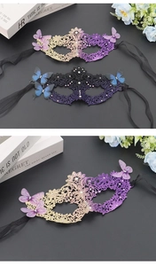 Detail of gradient butterfly masquerade mask with lace texture and rhinestone accents