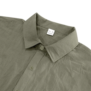 Detail of olive green linen shirt collar and texture with size XL label