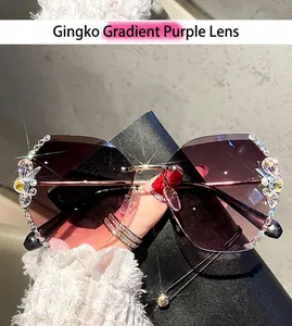 Close-up of rimless butterfly sunglasses with gradient purple lenses and crystal rhinestones