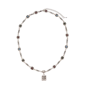 Vintage silver necklace with colorful gemstones and square floral pendant on white back