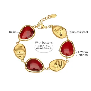 Detail of red irregular resin inlays on 18K gold-plated stainless steel bracelet