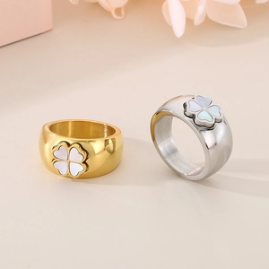 Detail of 11mm wide clover rings with white shell inlay in gold and silver steel finish