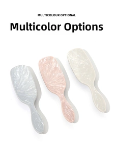 Close-up of three detangling hair brushes with marble texture handles in multiple colors