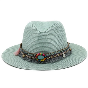 Detail of mint green straw fedora featuring colorful beads and boho fringe tassels