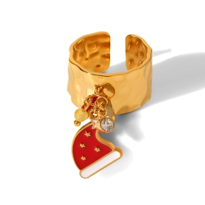 Detailed close-up of a golden Christmas ring with a red enamel hat and charms