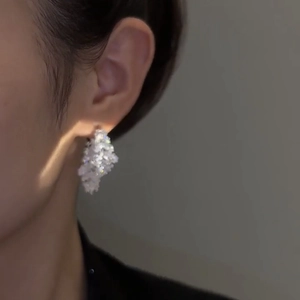 Sparkling leaf cubic zirconia stud earrings in silver finish worn by a model