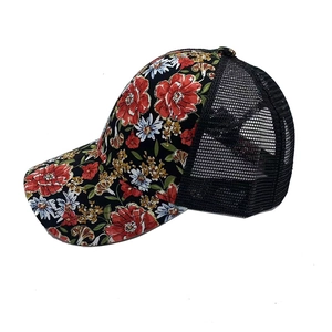 Side view detail of a floral print trucker hat with breathable black mesh back