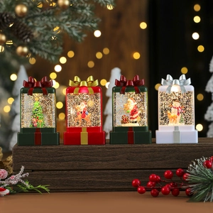 LED Christmas gift box lanterns with snow scenes and bows on a cozy wooden background