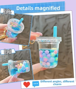 Macro detail of boba tea keychain showing blue liquid, colorful beads, and golden clasp