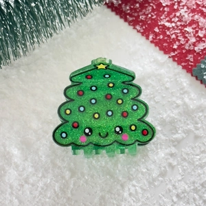 Sparkly green acrylic Christmas tree hair claw clip with smiley face and festive decorations