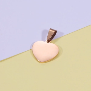 Detail of rose gold heart pendant with smooth mirror finish and bail for DIY jewelry