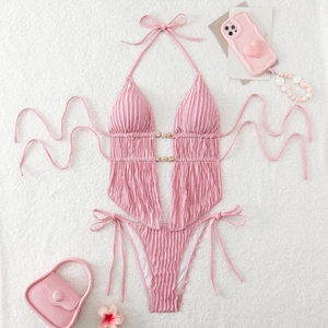 Detailed flat lay of pink halter monokini with ribbed texture and beaded waist cutout