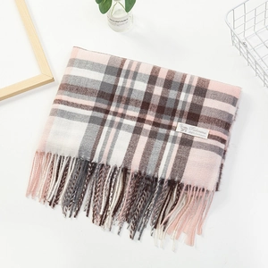 Detail of pink and grey plaid cashmere scarf with fringes and composition label