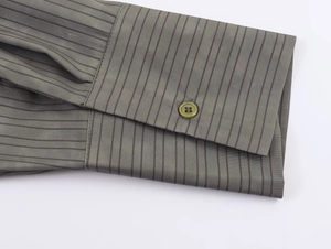 Close-up of sage green striped shirt cuff with button and fine woven fabric texture
