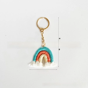 Detail of handmade knit rainbow keychain with dimensions 9.5cm height and cotton tassels