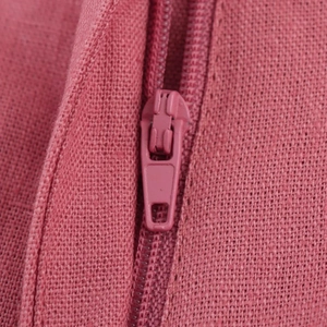 Close-up of a pink linen blend fabric with matching zipper detail on summer set