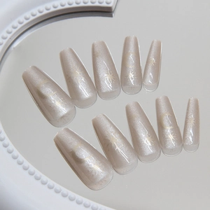 Champagne cat-eye press-on nails with sun and moon designs in long coffin shape