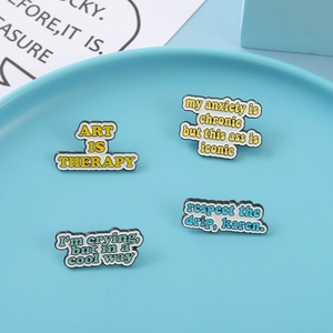 Modern enamel pins featuring art is therapy and sarcastic quotes in round light blue tray