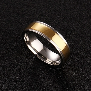 Macro detail of polished two-tone gold and silver stainless steel ring for couples