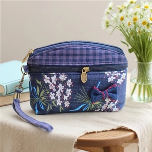 Blue floral and plaid patchwork coin purse with decorative bow and top handle