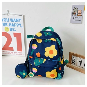 Detail of navy blue kids backpack with floral prints and round matching coin purse