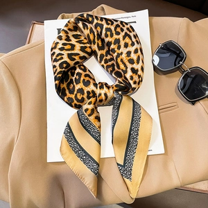 Chic leopard print satin silk scarf for women styled on khaki blazer and magazine
