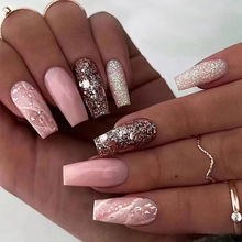 Detail view of long ballet press-on nails with pink, silver glitter and marble designs
