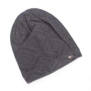 Detailed view of dark grey knitted beanie featuring diamond texture and metal plate