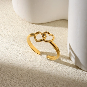 Detailed view of the double heart interlocking design on this gold adjustable open ring