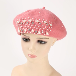 Close-up of pink cashmere beret featuring elegant hand-beaded pearls and rhinestones