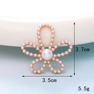 Macro detail of 3.7cm flower charm with white pearls on a gold base showing exact dimensions
