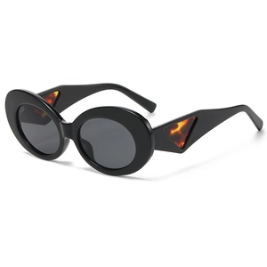 Fashionable black oval cat-eye sunglasses with tortoiseshell triangle temple detail