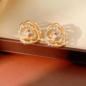 Elegant gold hollow rose stud earrings with sparkling crystals for a luxury floral style