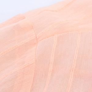 Detailed close-up of pink striped knit fabric showing texture and stitching quality