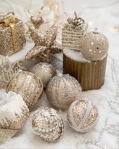 Detailed close-up of champagne gold Christmas ornaments and glitter stars in a festive set
