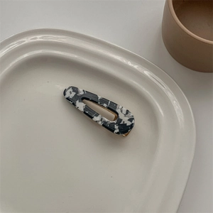 Macro shot of French vintage acetate hair clip with black and white marble patterns