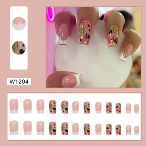 Pink and white French press-on nails with heart patterns and gold glitter accents
