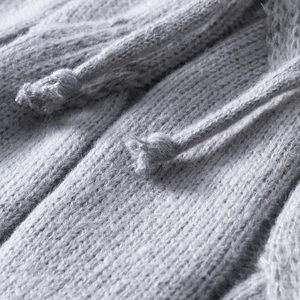 Macro view of light grey cable knit hoodie with detailed texture and matching drawstring