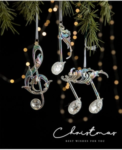 Exquisite musical note Christmas pendants with iridescent finish on a festive tree branch