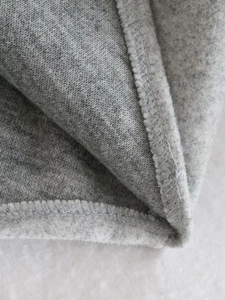Detailed macro view of gray fleece lining and durable double-stitch seams on a wool shirt jacket