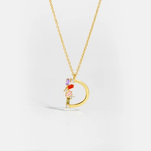 Detailed close-up of golden S925 silver letter D pendant with colorful zircon stones
