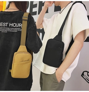 Detail of adjustable straps and zipper pockets on yellow and black nylon crossbody bags