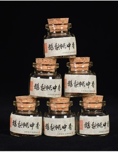 Set of six glass vials with cork stoppers containing traditional handmade incense beads