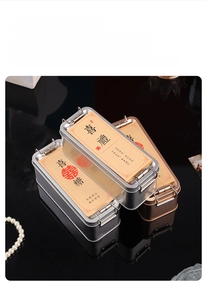 Close-up of elegant silver and rose gold metal wedding favor boxes with ornate lids