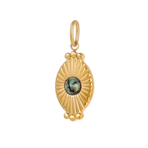 Macro shot of oval gold pendant featuring a turquoise stone and sunburst texture detail