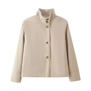 Detailed view of beige short wool coat featuring a stand collar and tortoiseshell buttons