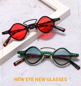 Detail view of vintage punk sunglasses with red and gradient lenses and tortoiseshell temples