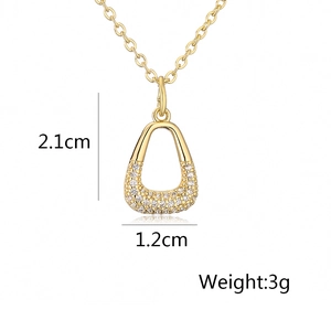 Detailed view of gold geometric pendant with zircon stones showing dimensions 2.1cm by 1.2cm