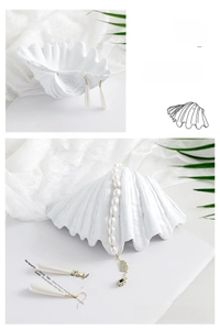 Macro detail of elegant white shell jewelry display stand with fine ribbed texture