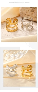 Close-up of vintage three-layer embossed open rings in gold and silver steel finish